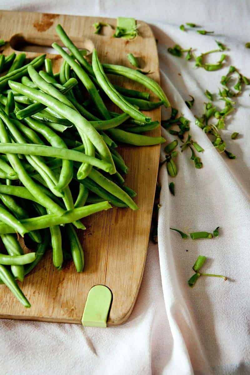Garlic Green Beans Recipe - Easy Low Carb Summer Side Dish 1 Green beans on a wood cutting board