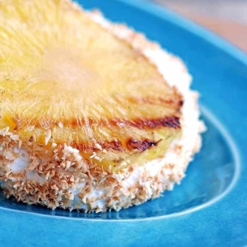 Tropical Ice Cream Sandwich made with grilled pineapple, vanilla ice cream and toasted coconut. Simple, family-friendly and delicious!