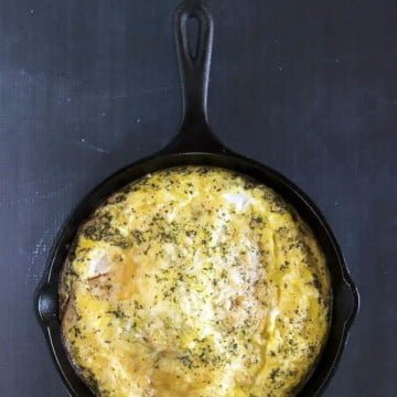 Turkey & Cheese Frittata recipe in a cast iron pan on a black background