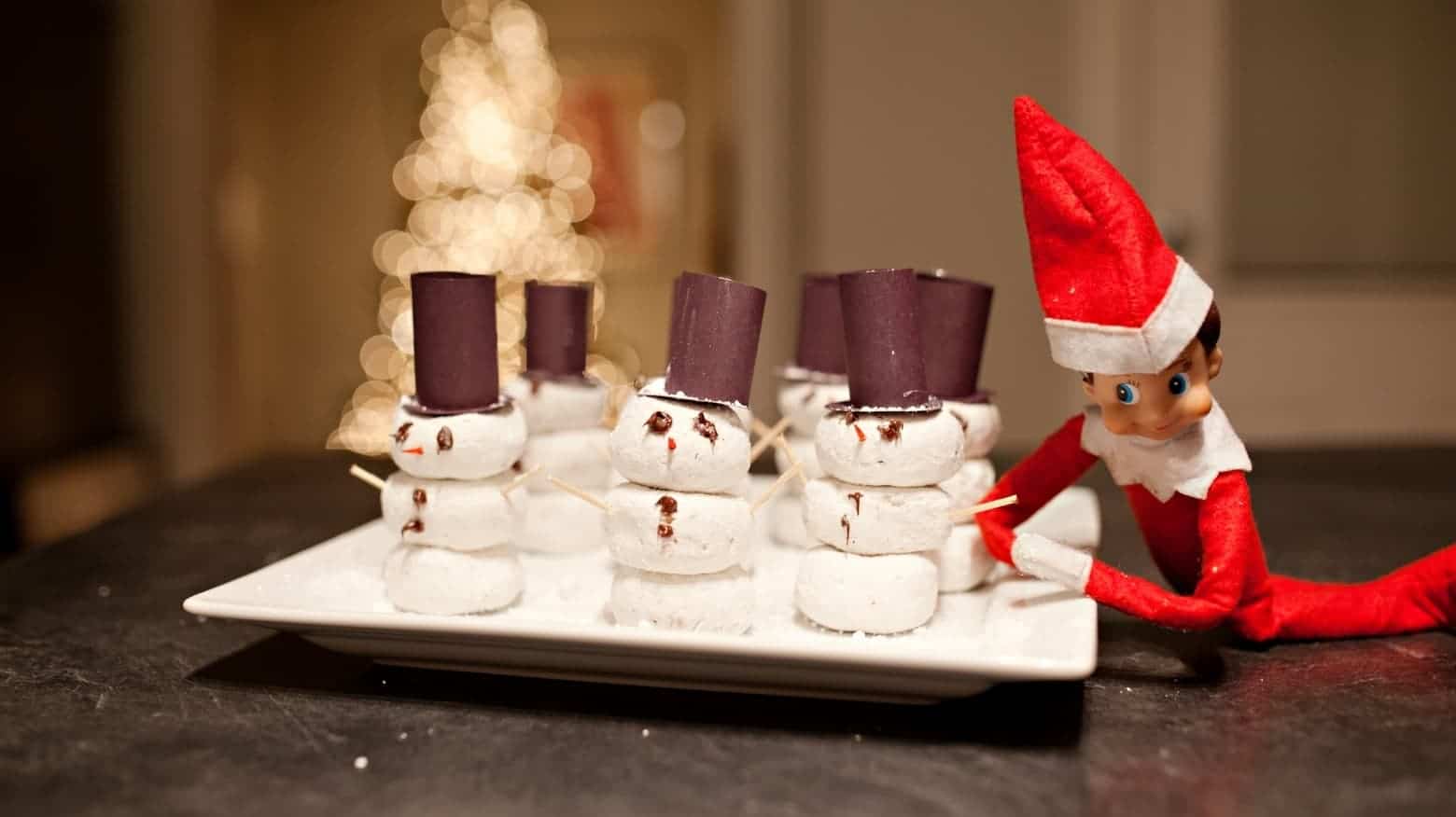 Elf on the shelf ready to eat marshmellow snowmen.