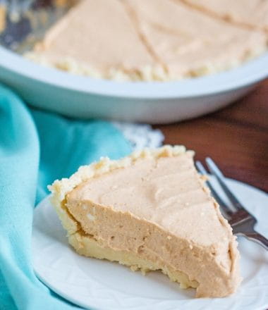low carb pumpkin cheesecake recipe on a plate with a blue background