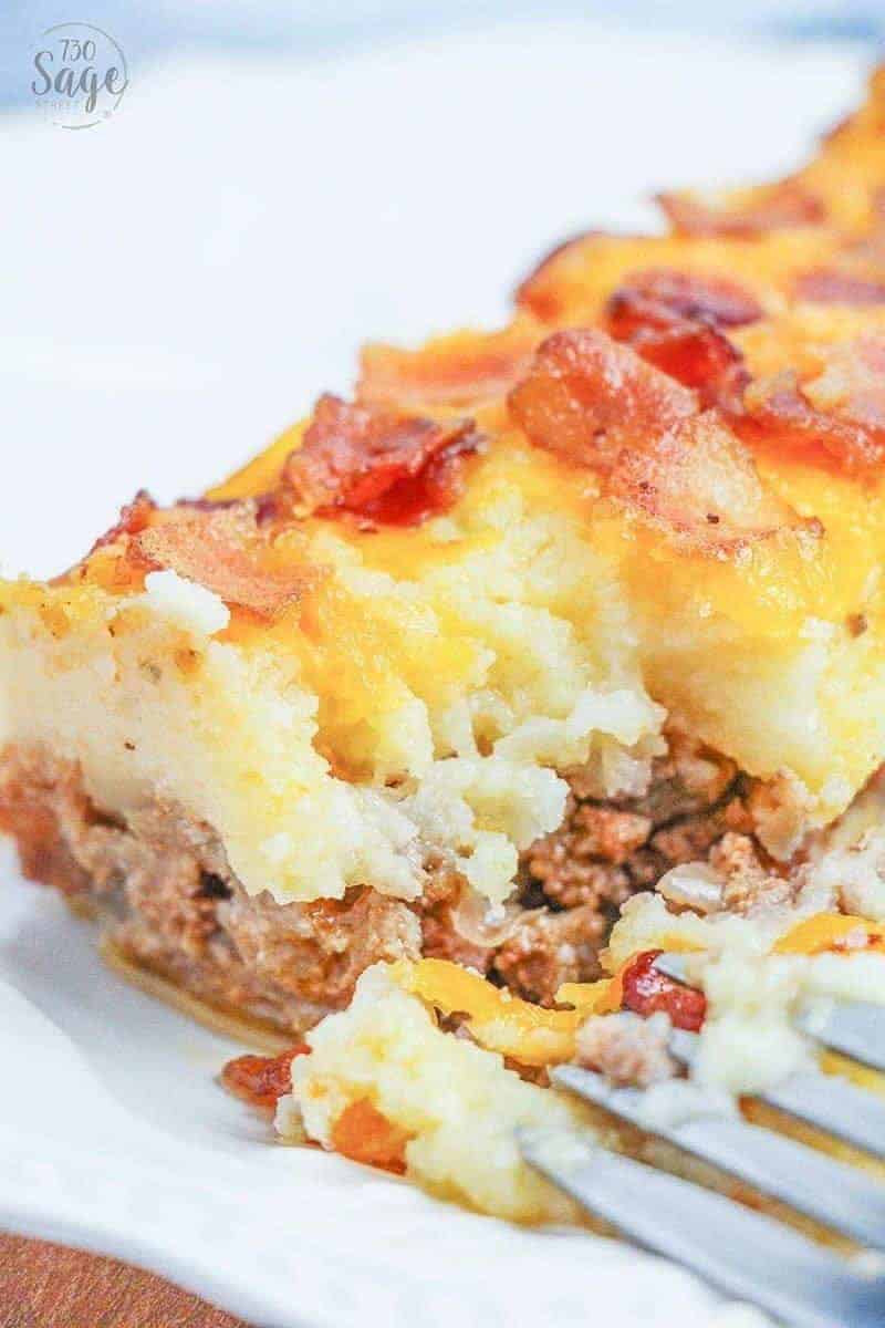 Picture of low carb cauliflower casserole with a piece of it on a fork.