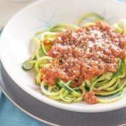 Side view of Low Carb Creamy Bolognese with Zucchini Noodles in a white bowl.