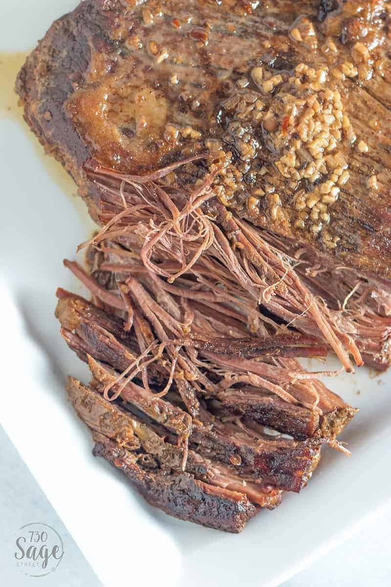 Keto Beef Brisket Korean Style 3 Overhead shot of a partially shredded korean beef on a white plate