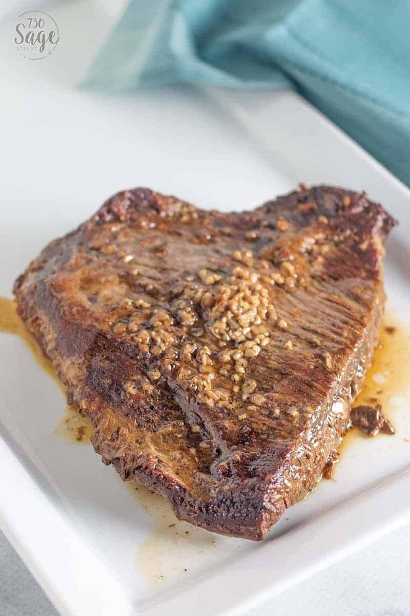 Keto Beef Brisket Korean Style 2 Whole beef brisket slow cooker on a white plate with blue background