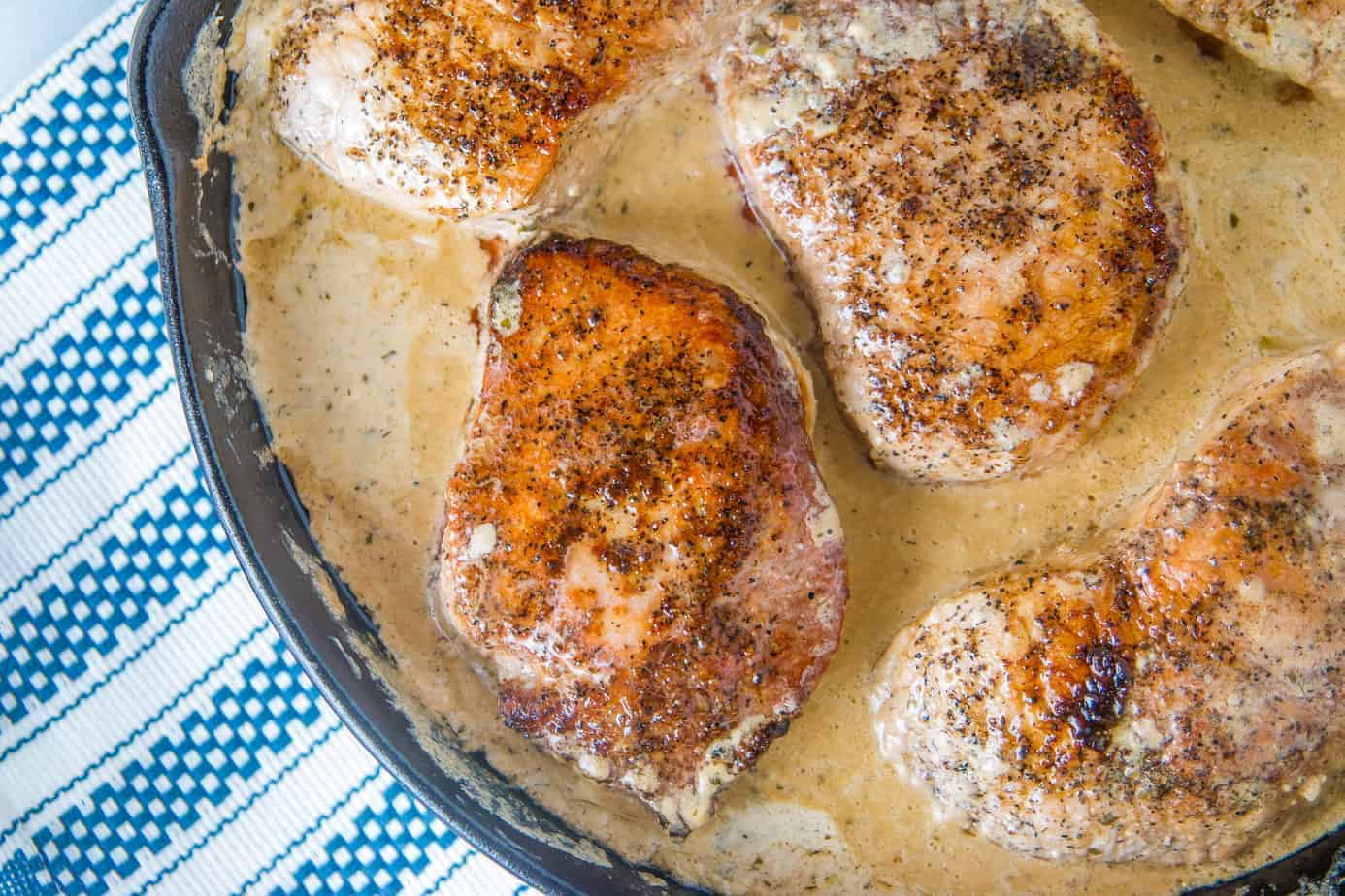 Keto Pork Chops with Homemade Ranch Seasoning 1 Boneless pork chops in skillet with creamy ranch sauce