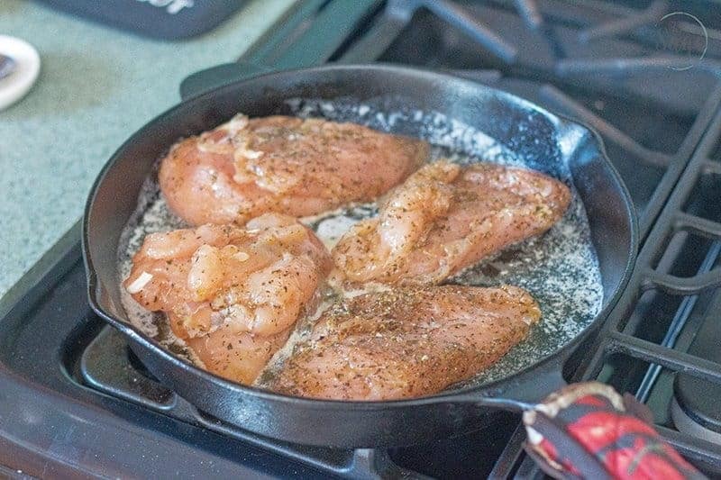 Raw chicken in a cast iron pan