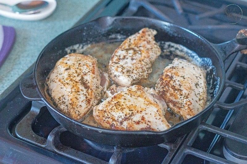 Low Carb Tomato Basil Creamy Tuscan Chicken Alfredo 5 Cooked chicken in a cast iron pan