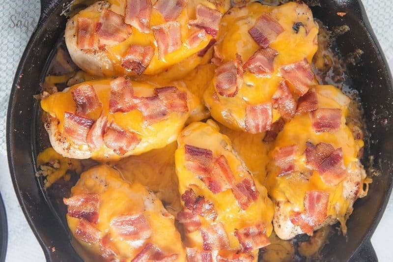 6 low carb chicken breasts with cheese and bacon in a cast iron skillet