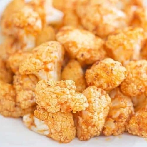 sriracha cauliflower airfryer recipe on a white plate with a blue background