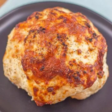 whole roasted cauliflower on a grey plate