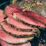bottom round roast sliced in a cast iron pan