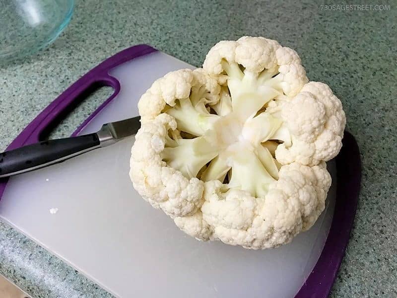 whole cauliflower head on a cutting board