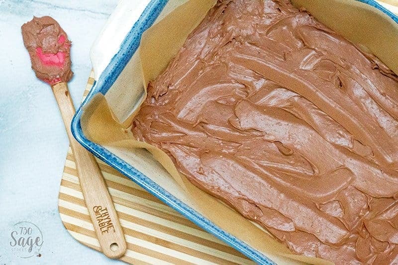 keto fudge in a blue pan on a wooden cutting board