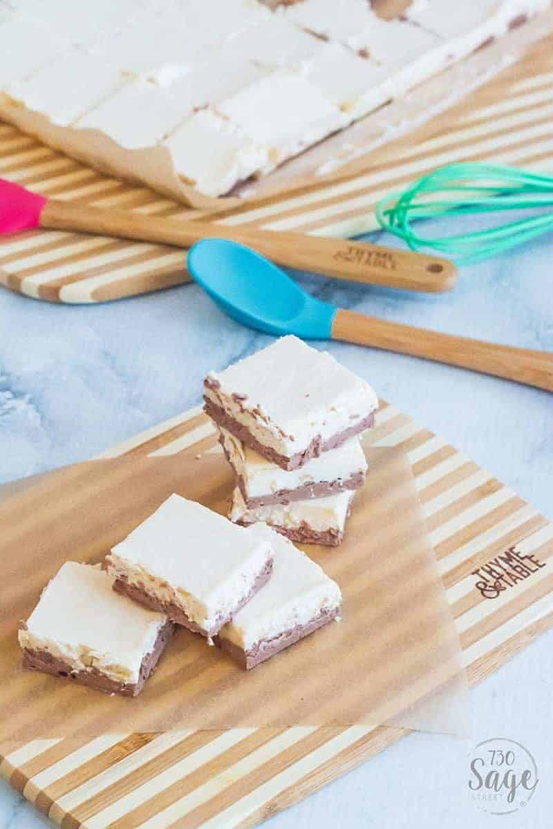 Pieces of keto fudge on a wooden cutting board