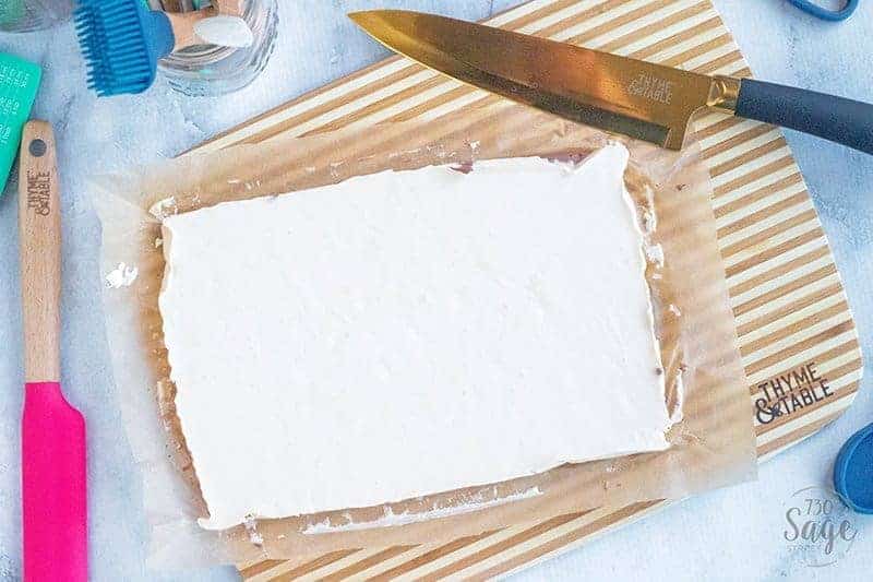 slab of keto fudge on a wooden board