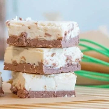 3 pieces of brown and white keto fudge stacked on top of each other