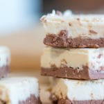 3 pieces of brown and white keto fudge stacked on top of each other