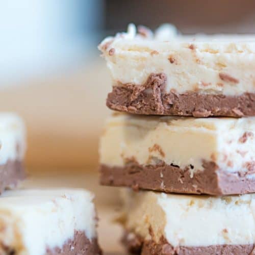3 pieces of brown and white keto fudge stacked on top of each other