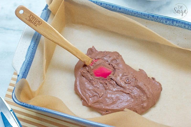 a spatula spreading keto fudge into a pan