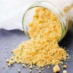low carb breadcrumbs spilling on a grey background in a glass jar
