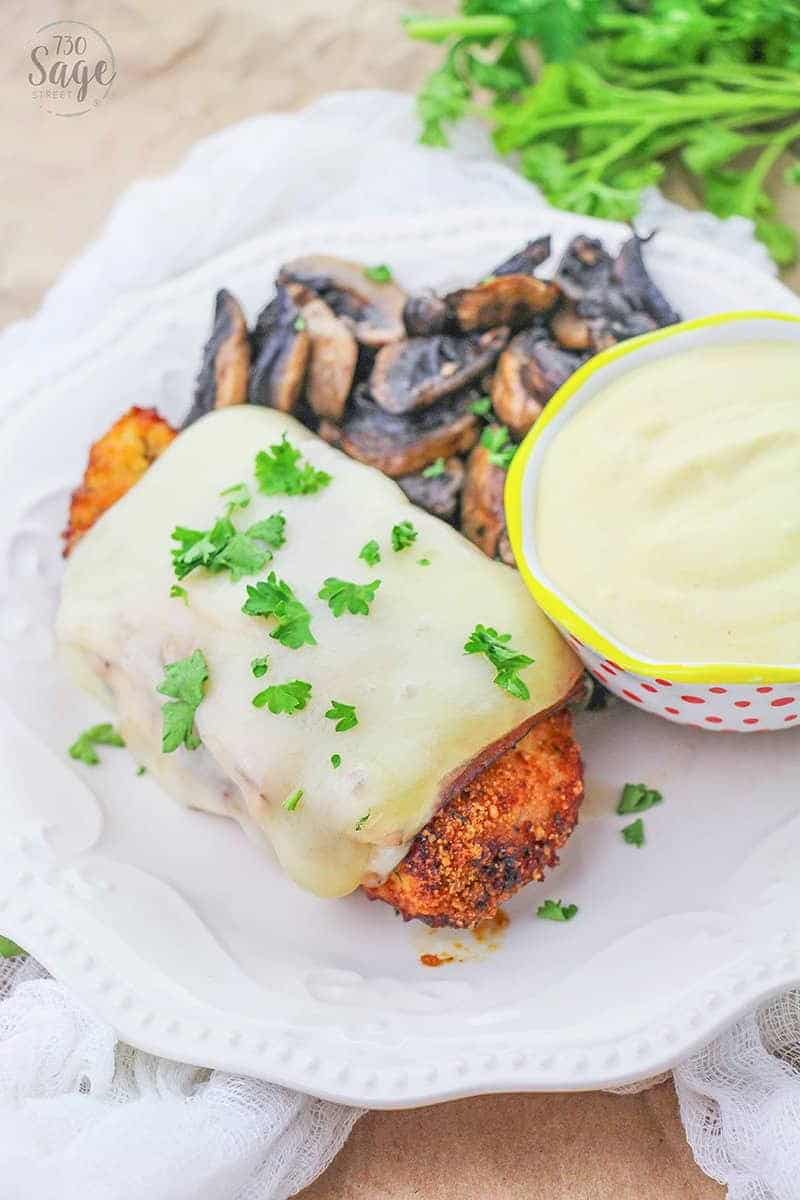 Low carb malibu chicken on a white plate with mushrooms and dipping sauce