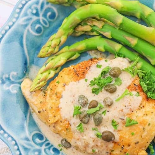 low carb chicken piccata on a blue plate