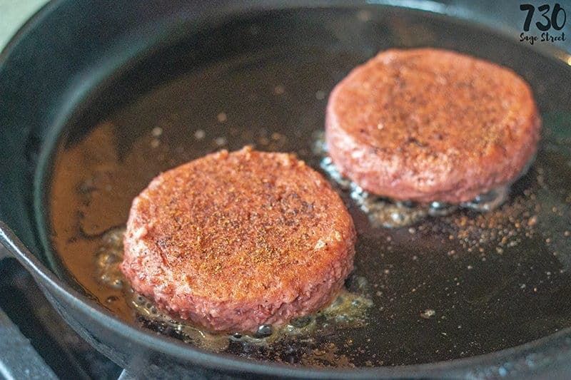 The beyond burger cooking in a pan