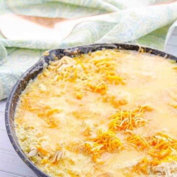 Keto Sour Cream Chicken Enchiladas 3 sour cream chicken enchiladas in a cast iron pan