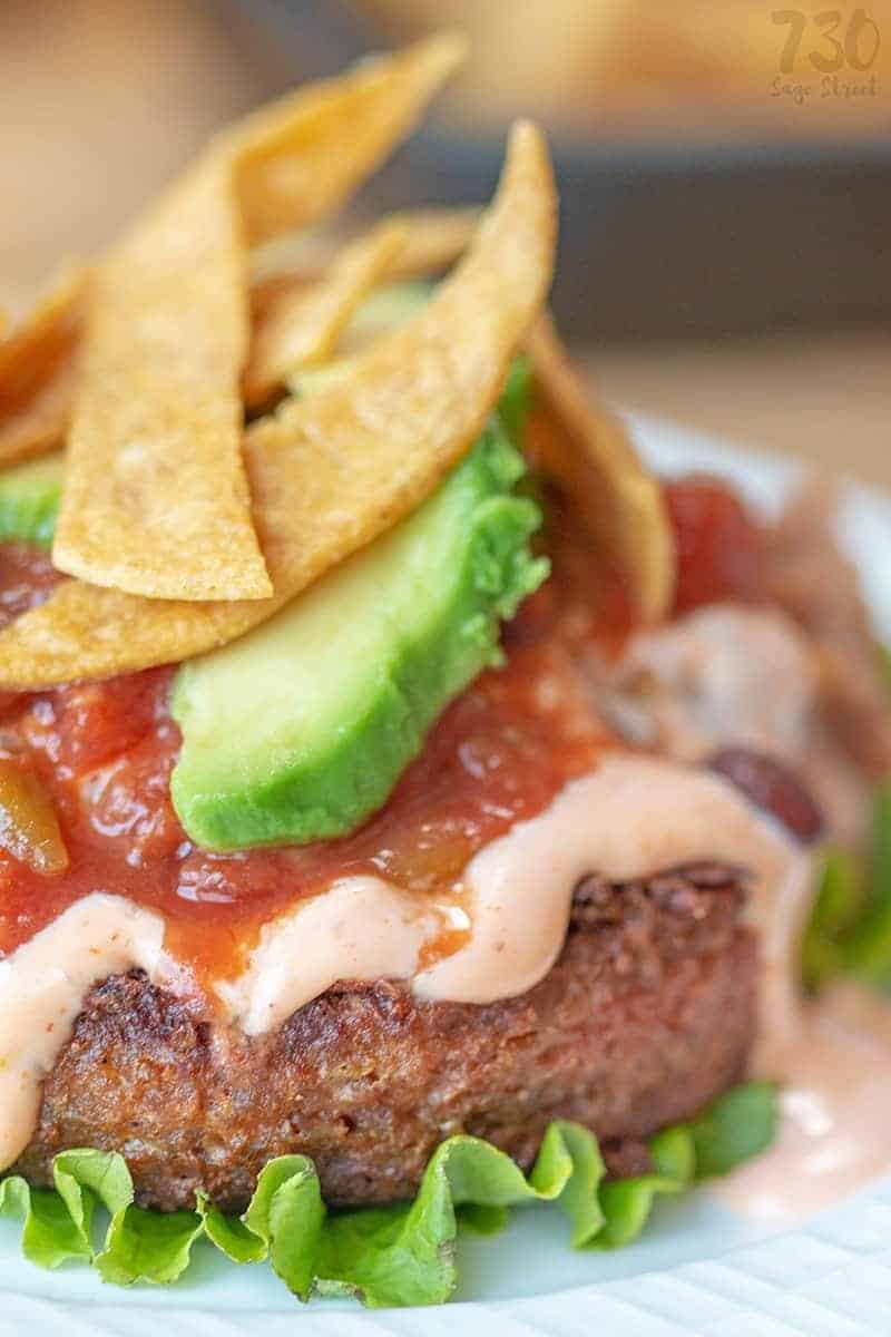 Get 20 Grams Of Plant Based Protein In This Delicious Taco Burger Recipe. It's Gluten Free, Dairy Free, Vegan And Easy To Make Low Carb For Keto Diets. #Mexican #Plantbased #Vegan #Veganrecipes #Glutenfree #Dairyfree #Keto #Ketorecipes #Lowcarb #Healthyrecipes #Wholefood Close up of a taco burger