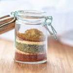 adobe seasoning in a glass jar on a wood board