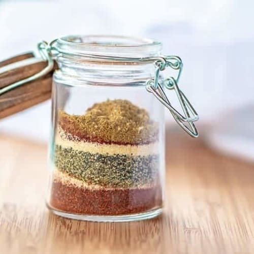 adobe seasoning in a glass jar on a wood board