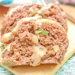 sliced low carb meatloaf on a wood cutting board