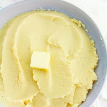 Mashed Cauliflower Recipe - Low Carb and Keto Friendly 4 top view of mashed cauliflower in a grey bowl with a pat of butter