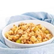 vegan stuffing in a white bowl sitting on a blue towel