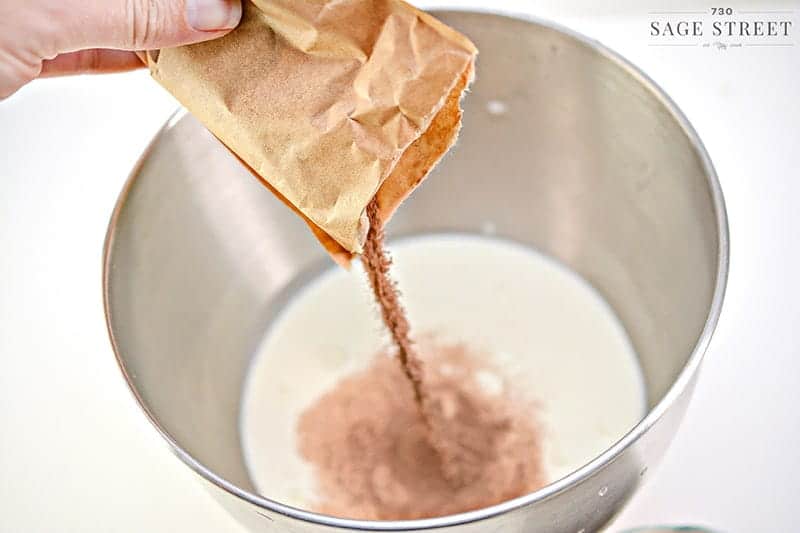 chocolate pudding mix being poured into a bowl
