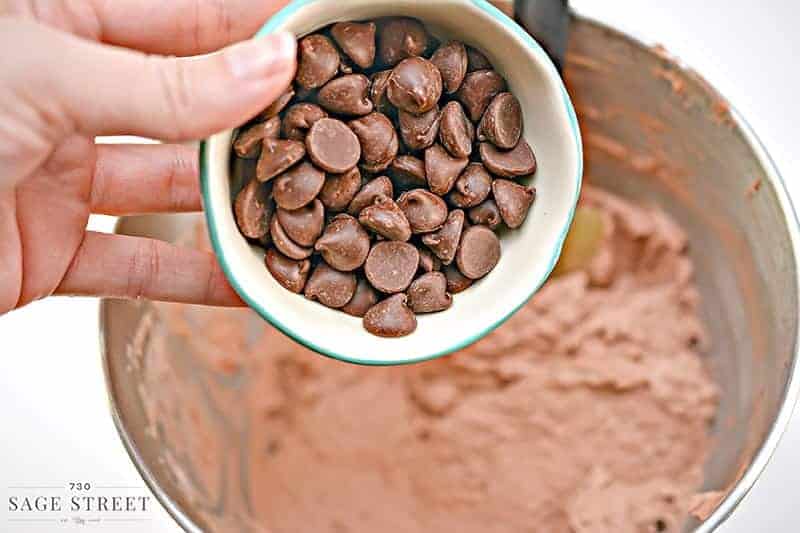 chocolate chips being poured into a bowl