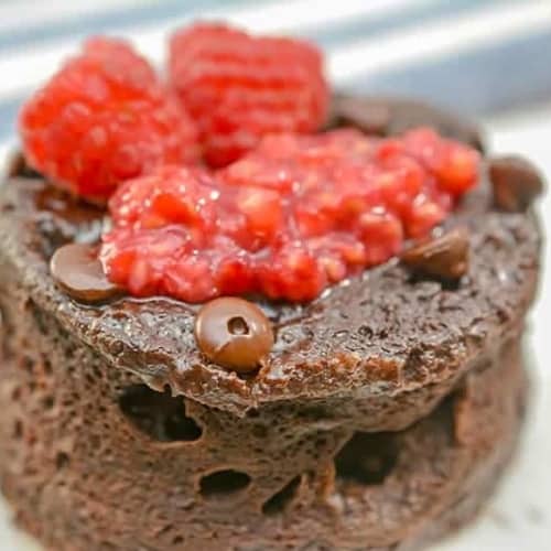 chocolate keto mug cake with raspberries on top