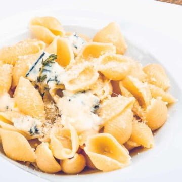 garlic butter pasta shells in a white bowl