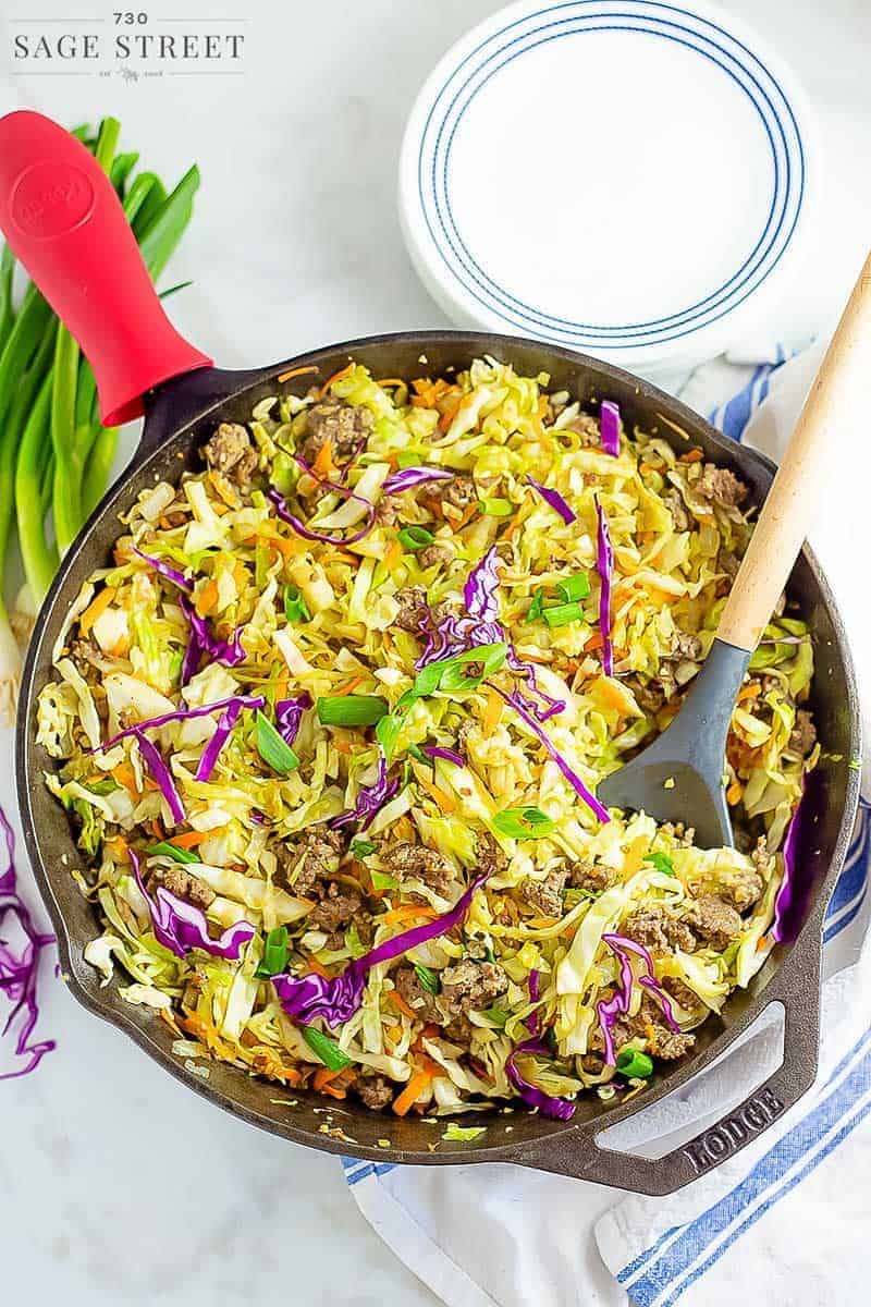 keto egg roll in a bowl recipe being cooked in a cast iron pan