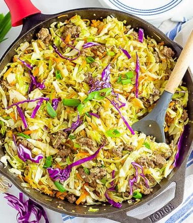 keto egg roll in a bowl recipe being cooked in a cast iron pan