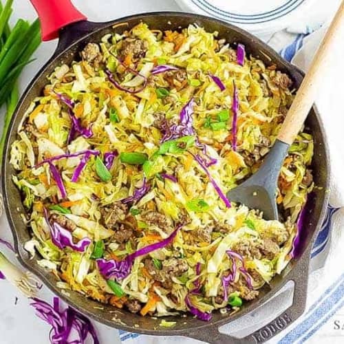 keto egg roll in a bowl recipe being cooked in a cast iron pan