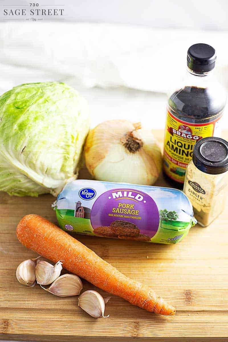 keto egg roll in a bowl ingredients on a wooden cutting board
