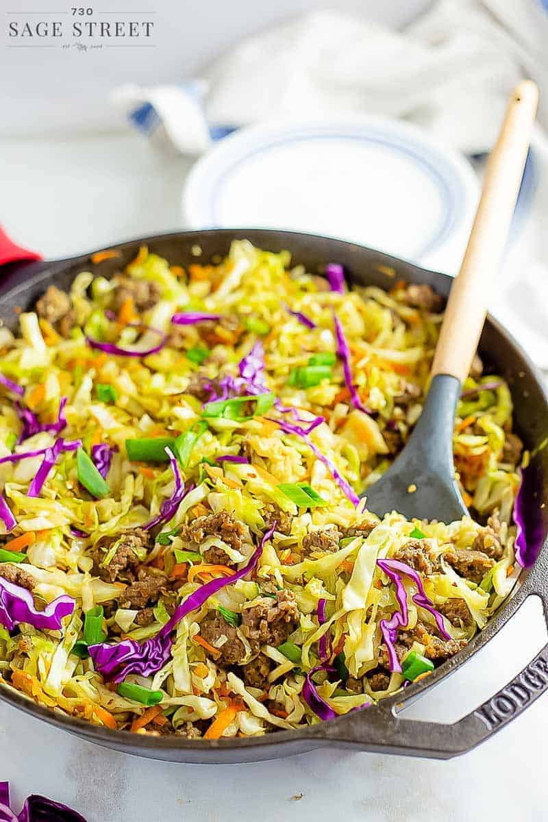 keto egg roll in a bowl recipe being cooked in a cast iron pan