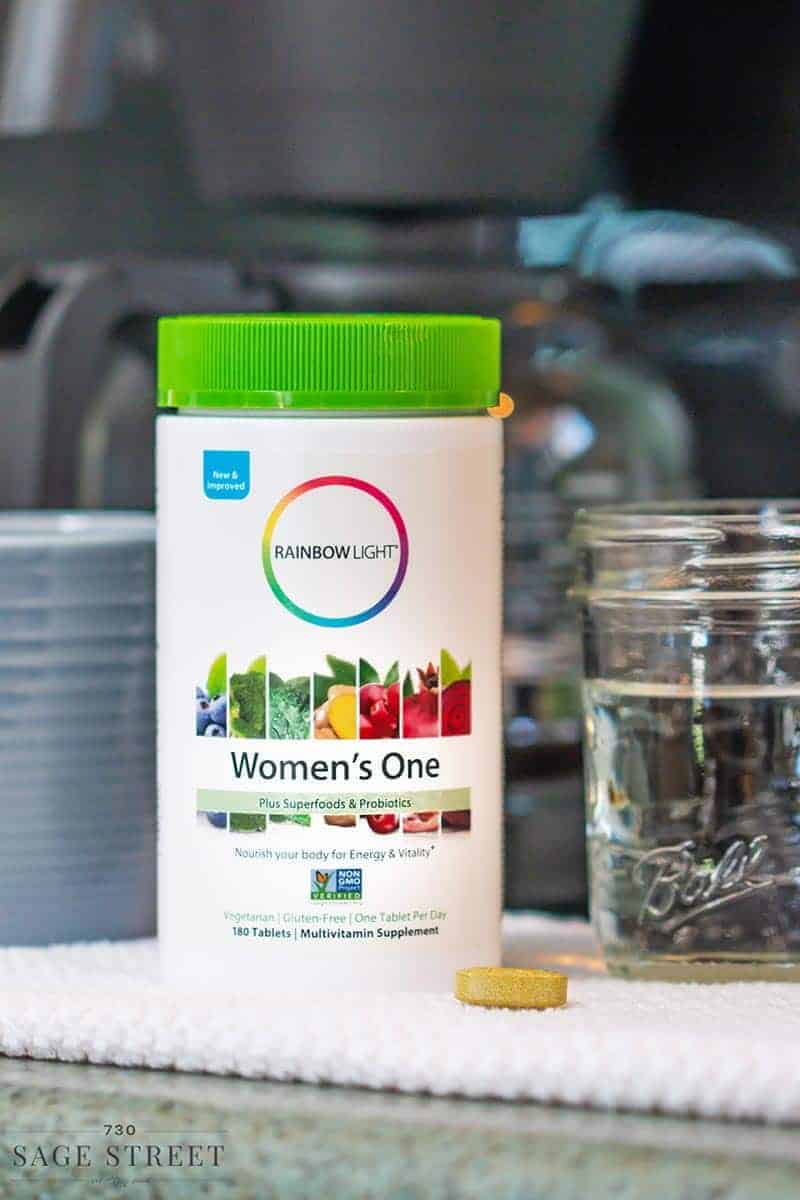 Rainbor Light Women's One multivitamin bottle in front of a coffee pot