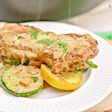Keto Creamy Mustard Pork Chops with Sauteed Vegetables 14 keto mustard pork chops on veggies on a white plate