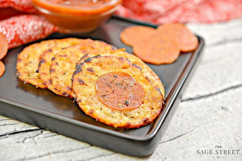 Keto Cheese Crisps 1 keto cheese crisps on a black plate