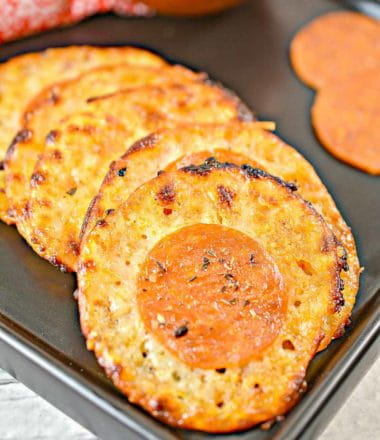 pepperoni pizza cheese crisps on a black plate