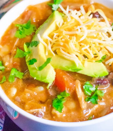 close up of enchilada soup in a white bowl