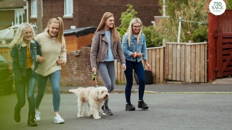 Teenagers walking their dog, helping with chores